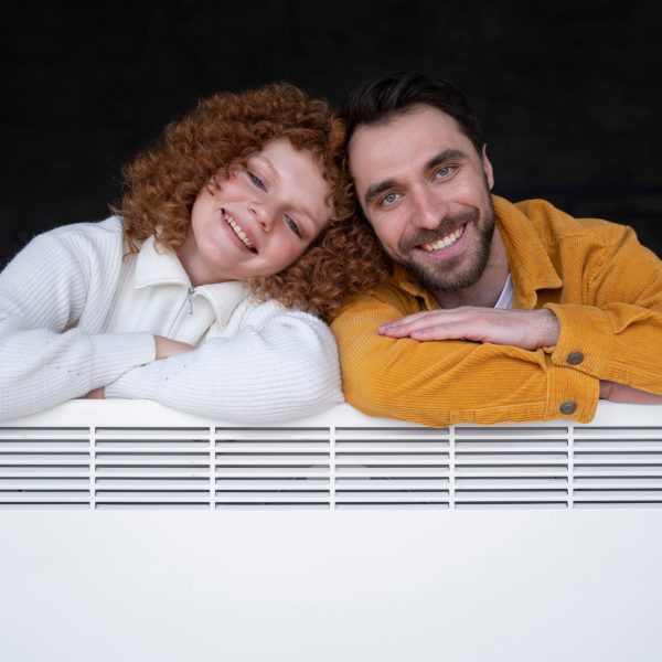 medium-shot-smiley-couple-with-heater