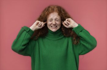 portrait-teenage-girl-covering-her-ears-min