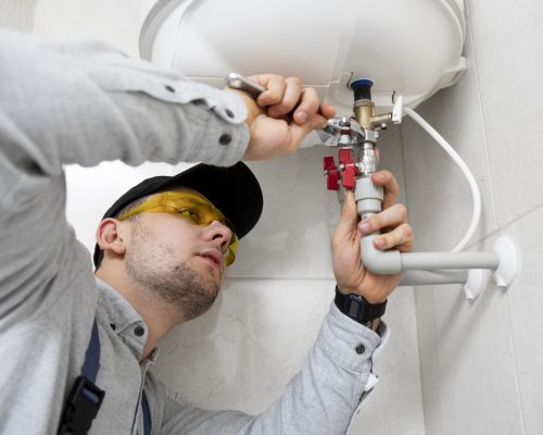 worker-repairing-water-heater